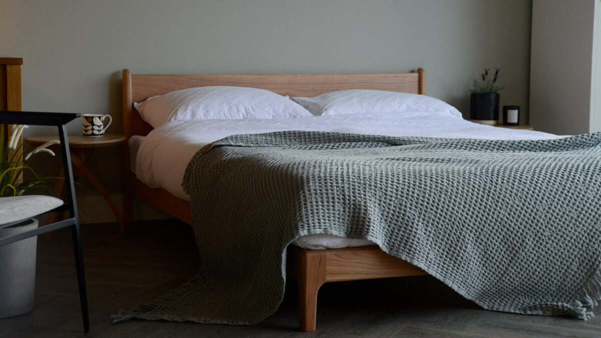 contemporary country bedroom look - solid cherry low wooden Pimlico bed and sage throw