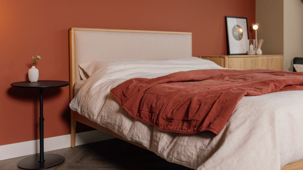 solid oak Carlisle bed with Amatheon headboard and brick colour quilt