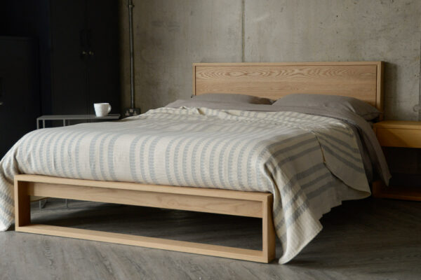 solid oak Leith bed with ivory and grey bedspread
