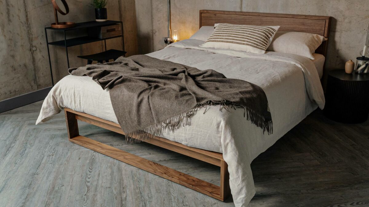 solid walnut Leith bed with ecru linen bedding and alpaca throw