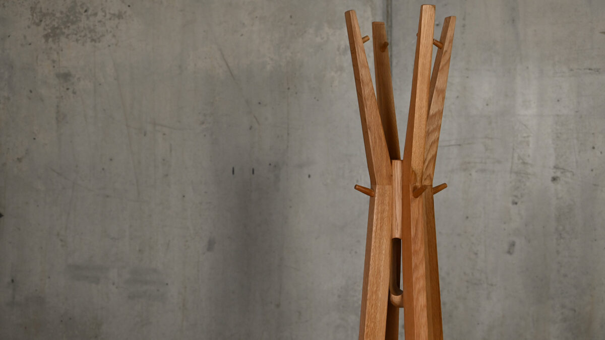Spire coat stand closeup view of top hanging portion of item.
