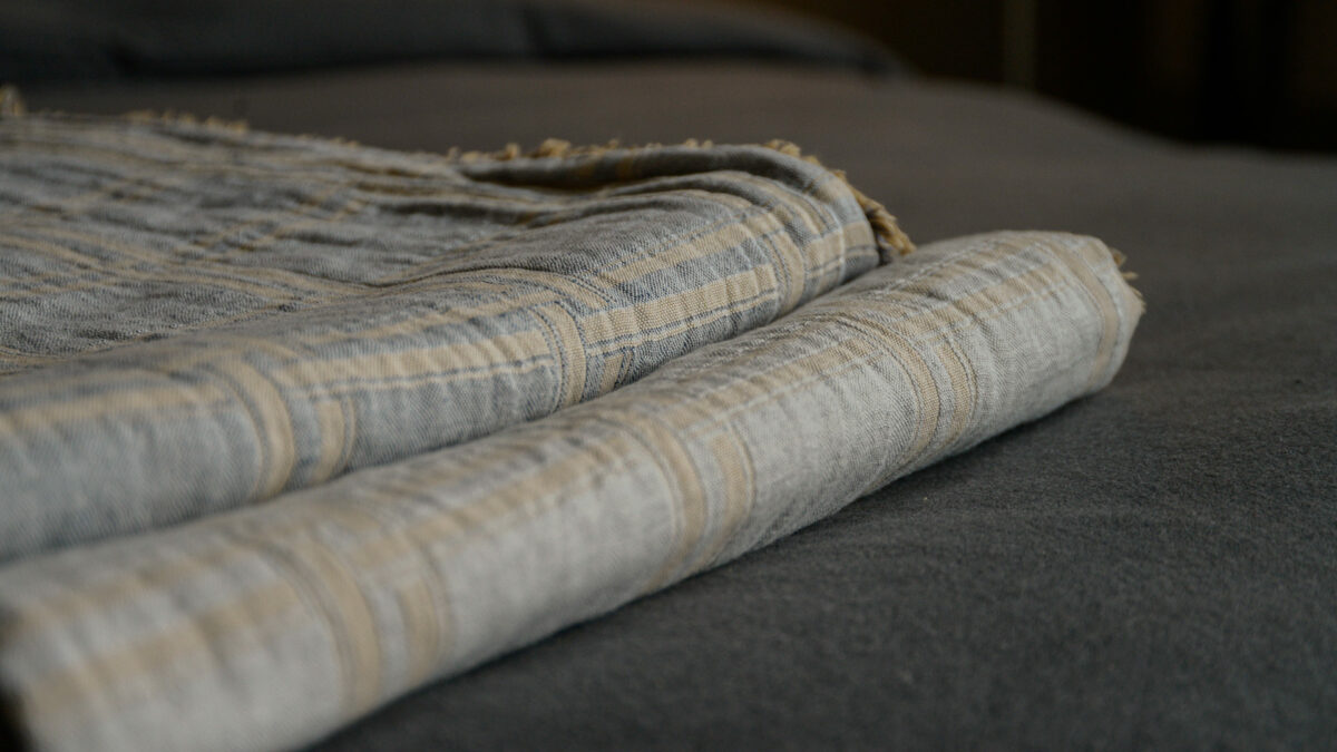 stack of check throws in grey and gold