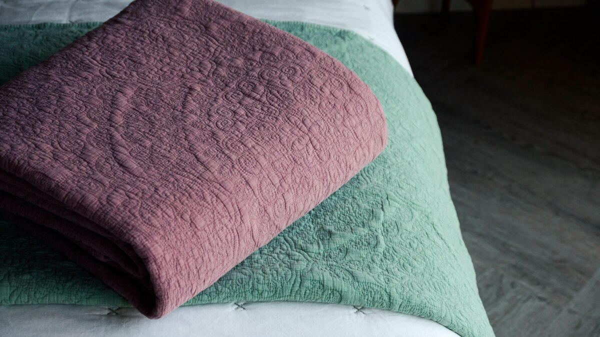 stonewash effect stitched and quilted bedspreads in wine red and sage green