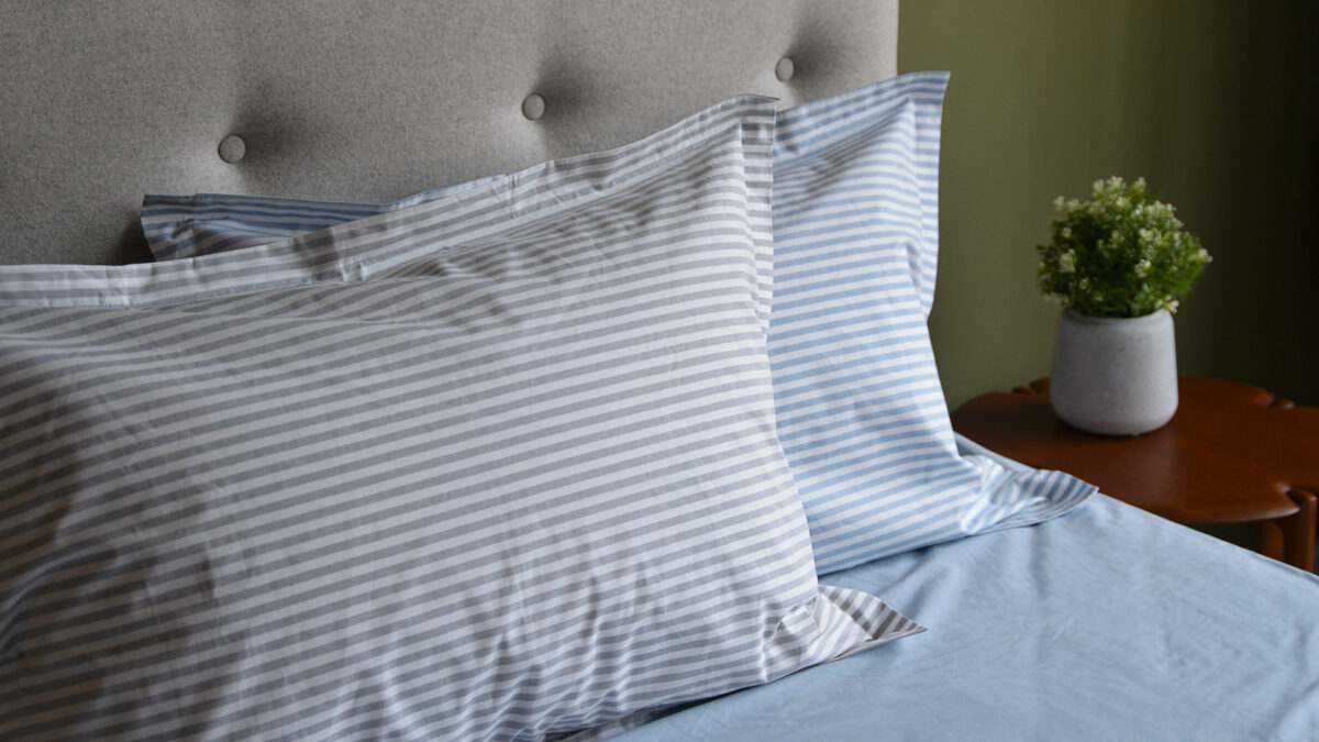 Blue and white, and grey and white striped cotton pillowcases.