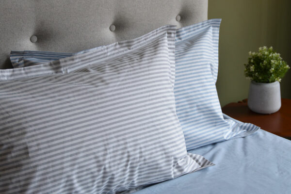 Blue and white, and grey and white striped cotton pillowcases.