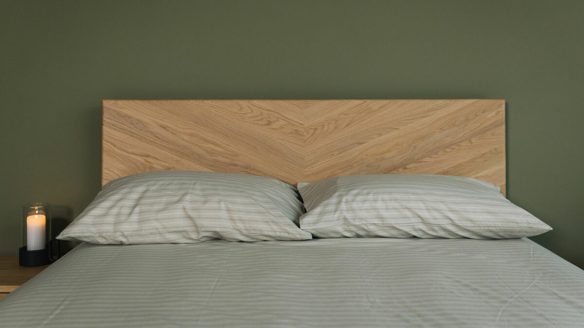 sage green striped fitted sheet and pillowcase set shown on an Oak Highbury bed