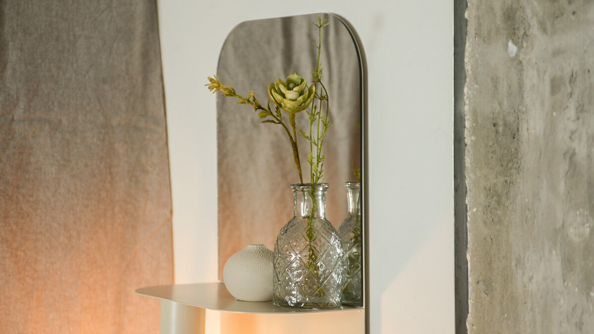 metal bedside shelf with small vase and flowers