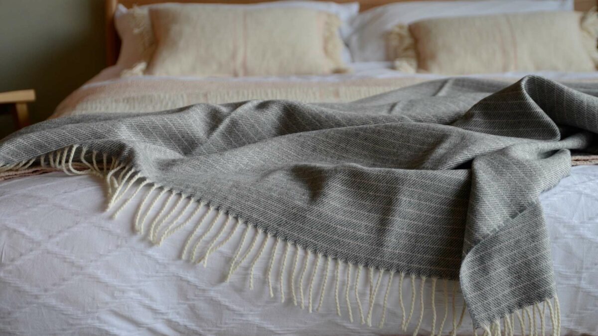 grey and pale pink throw