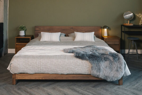 Sonora a modern low solid wood bed here made from Walnut and shown with walnut bedside tables