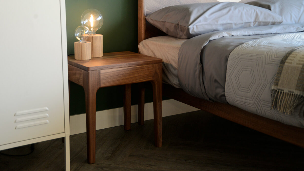 Tall camden table in walnut shown next to a Hoxton bed