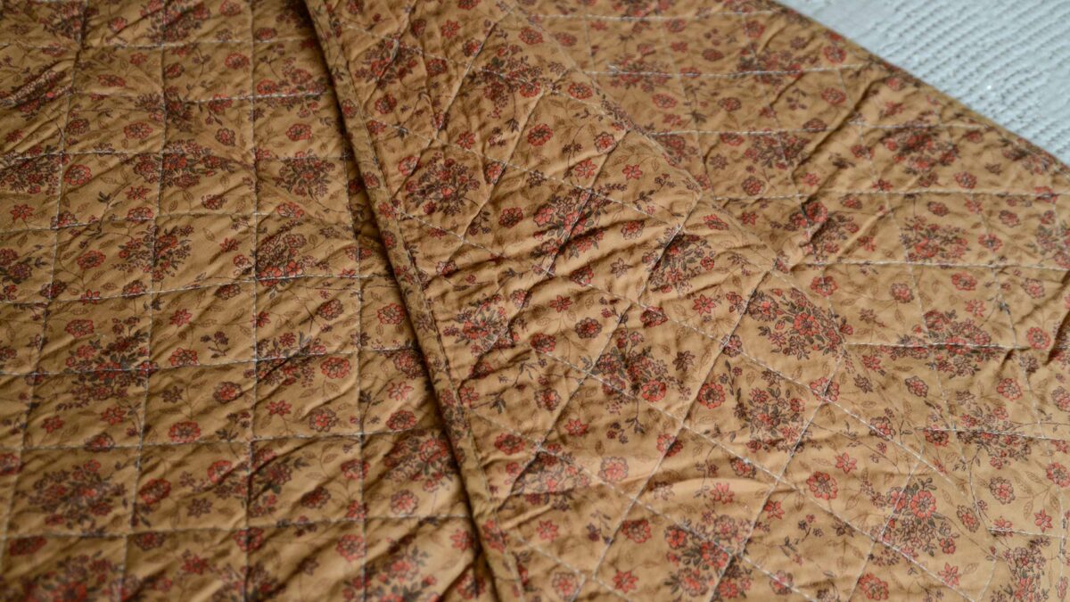 muted terracotta shades floral quilted bedspread