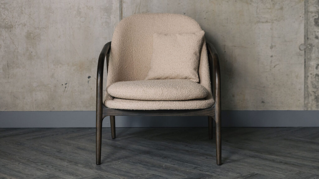 taupe upholstered chair with dark wood frame