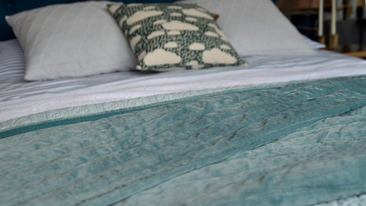 Harlquin embroidered bedspread in teal