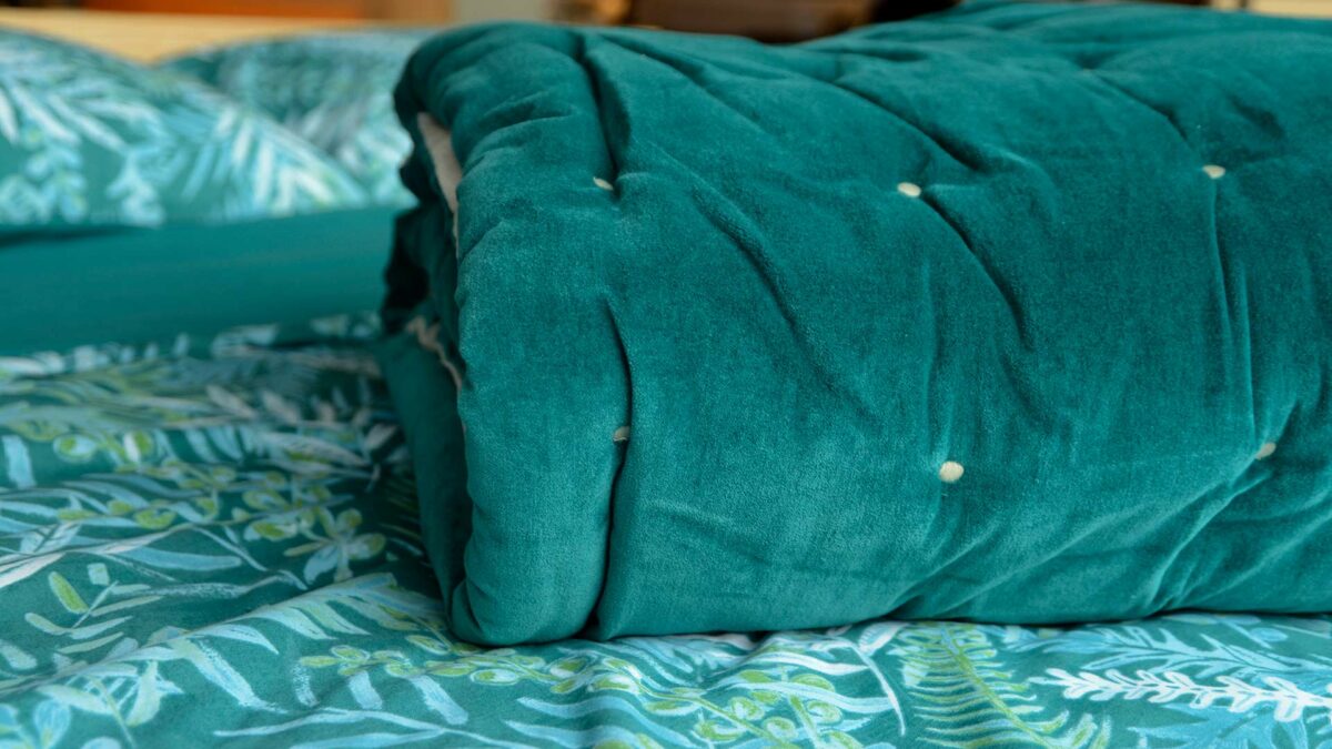 teal coloured velvet quilt with cotton fabric reverse