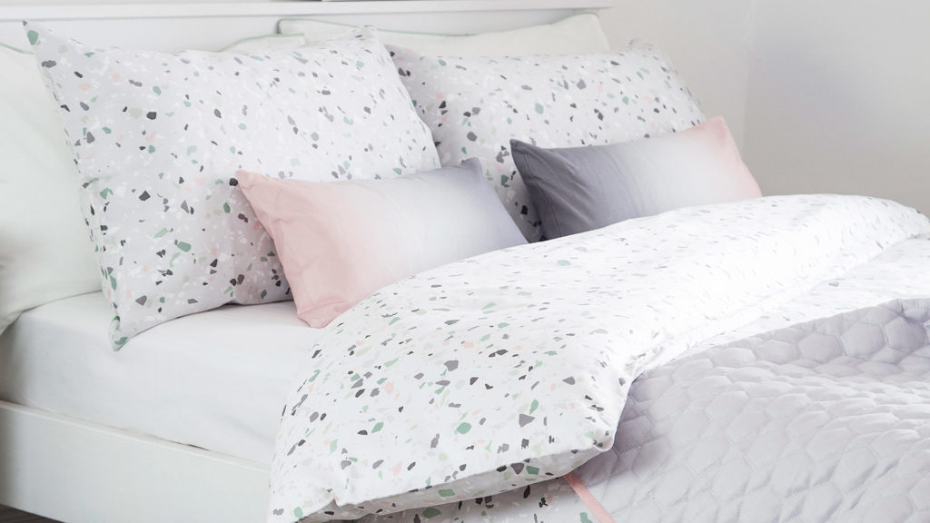 printed terrazzo pattern duvet cover set shown with contrast tonal colour cushions