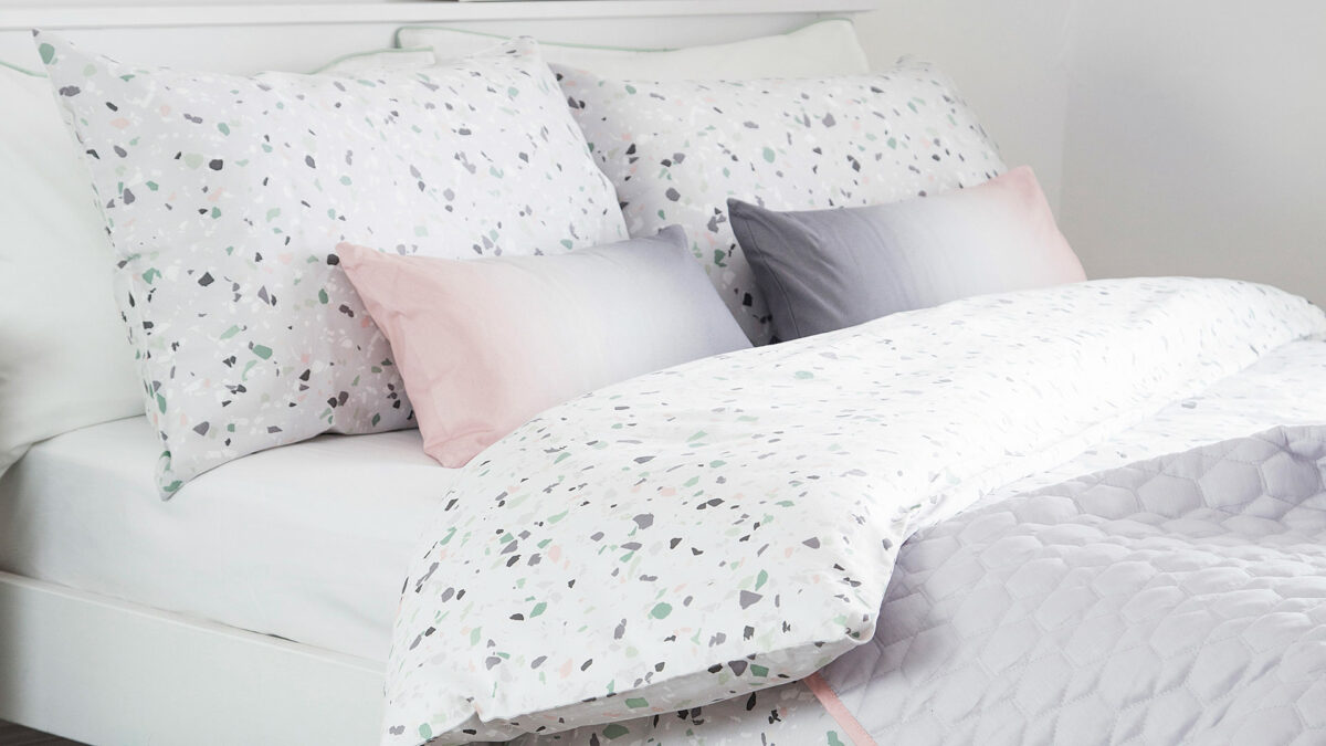 terrazzo print duvet cover set shown with ombre pink-grey cushions