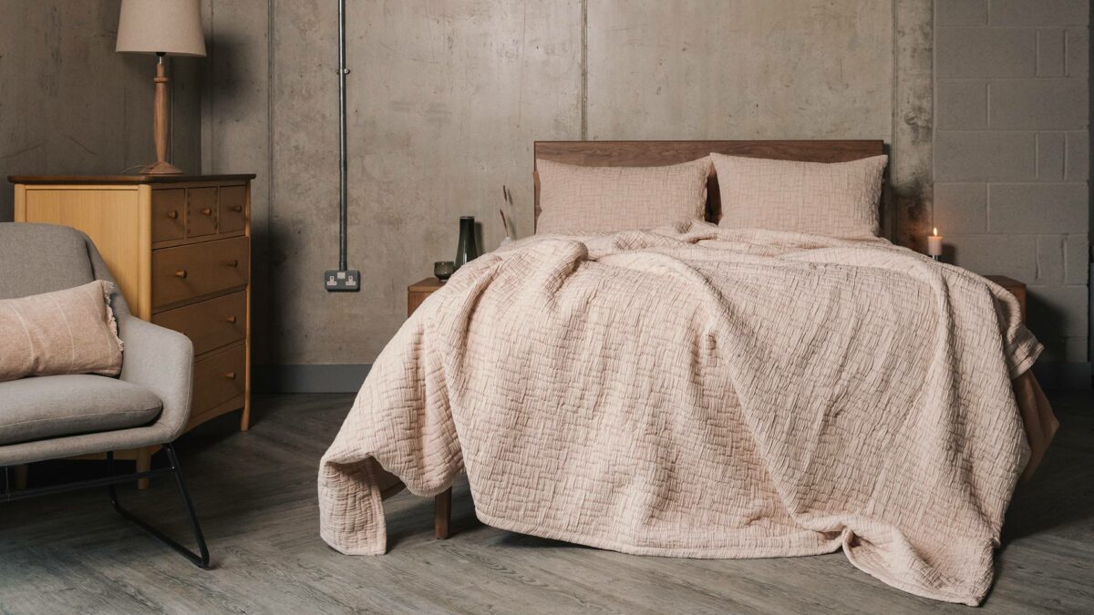 textured bedspread and pillowcase set in Blush pink shown on a kingsize bed