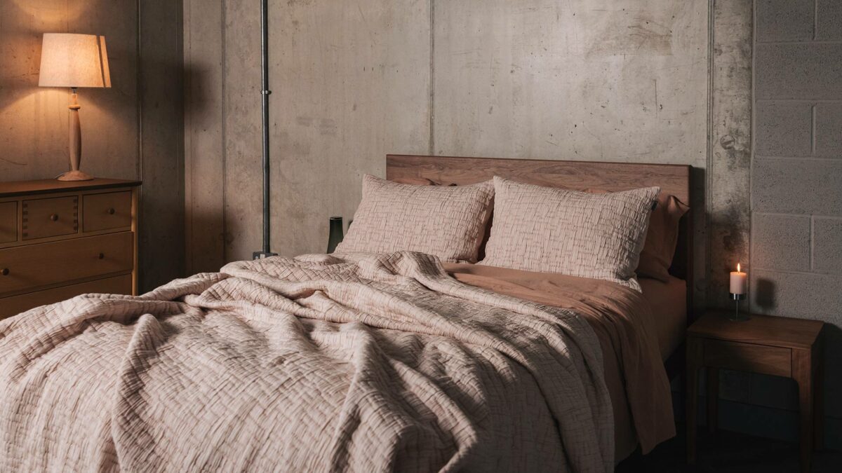 textured bedspread and pillowcase set in Blush pink shown on a kingsize bed