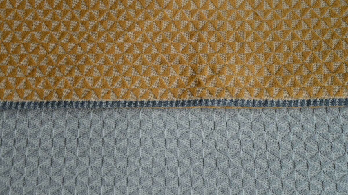 textured triangle pattern on bedspreads in grey or mustard