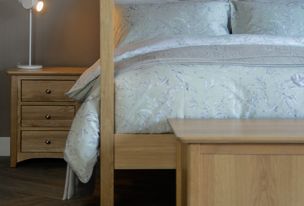 traditional style oak bedside table with 3 drawers shown with our Highland bed