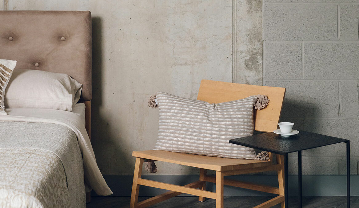 oak low chair shown with a metal framed side table both by Ethnicraft