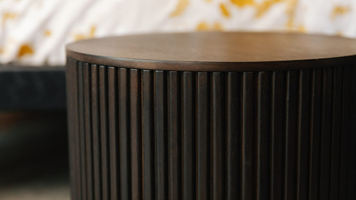 a close up view of the storage stool or side table in dark mahogany