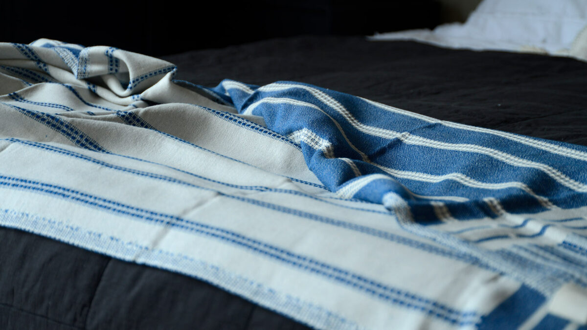 reversible blue and ivory coloured woven cotton throw