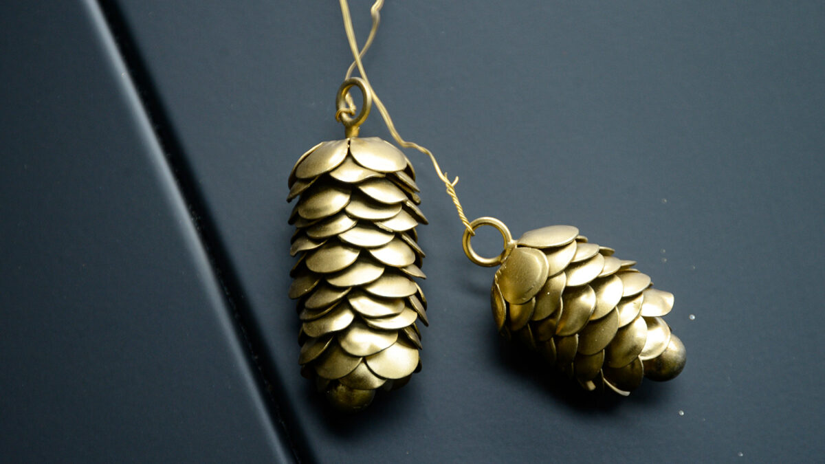 two gold colour pine cone decorations