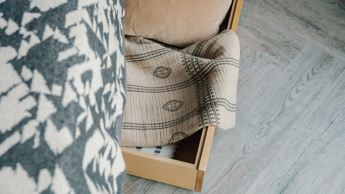 under bed drawer with boho print throw