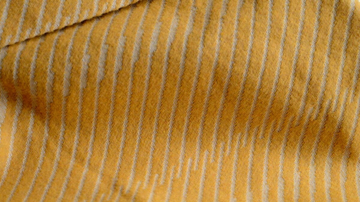 soft cotton striped bedspread in yellow ochre shown close up