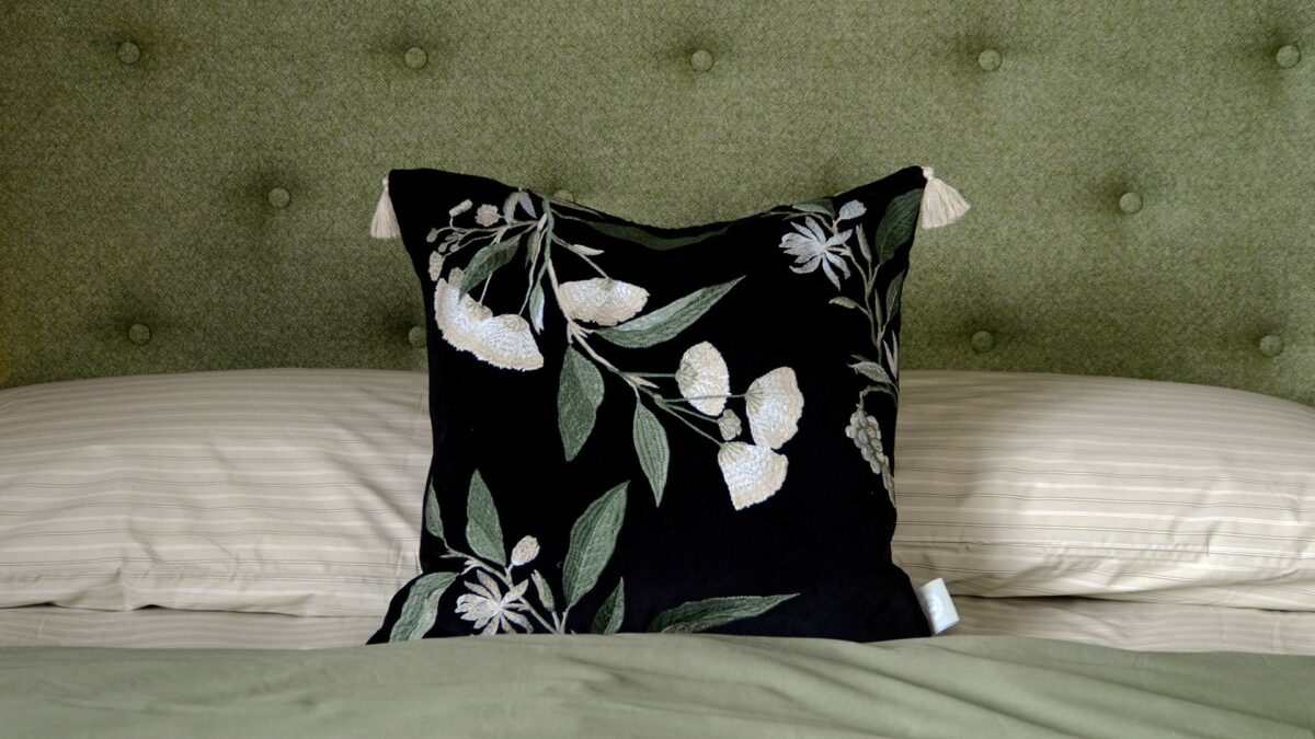 velvet floral embroidered black cushion with tassles