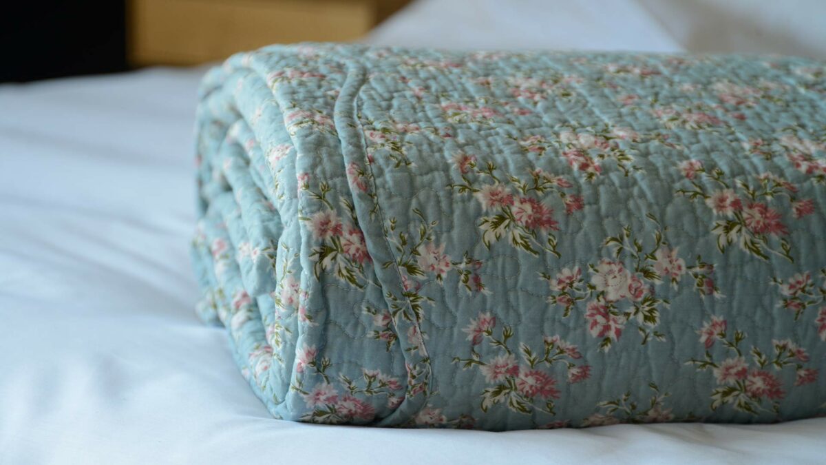 vintage look floral print bedspread in blue and pink