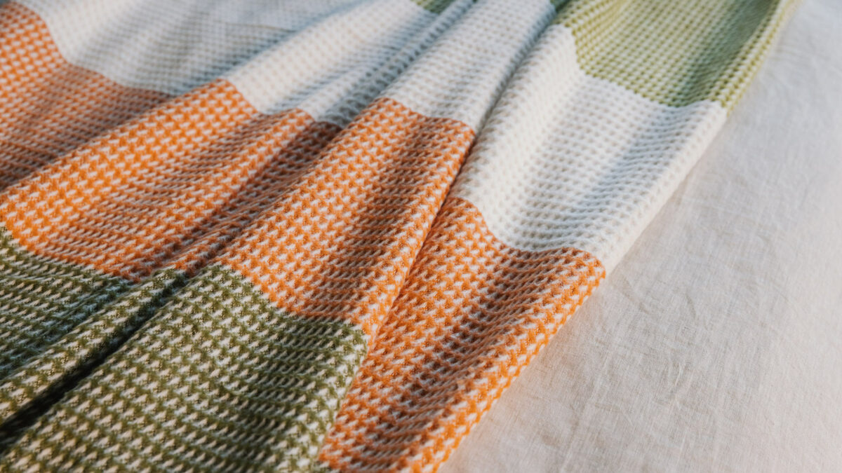 waffle knitted colour block throw in white green and orange