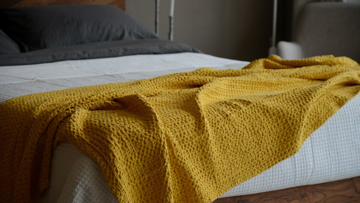 waffle weave cotton throw in a turmeric yellow colour