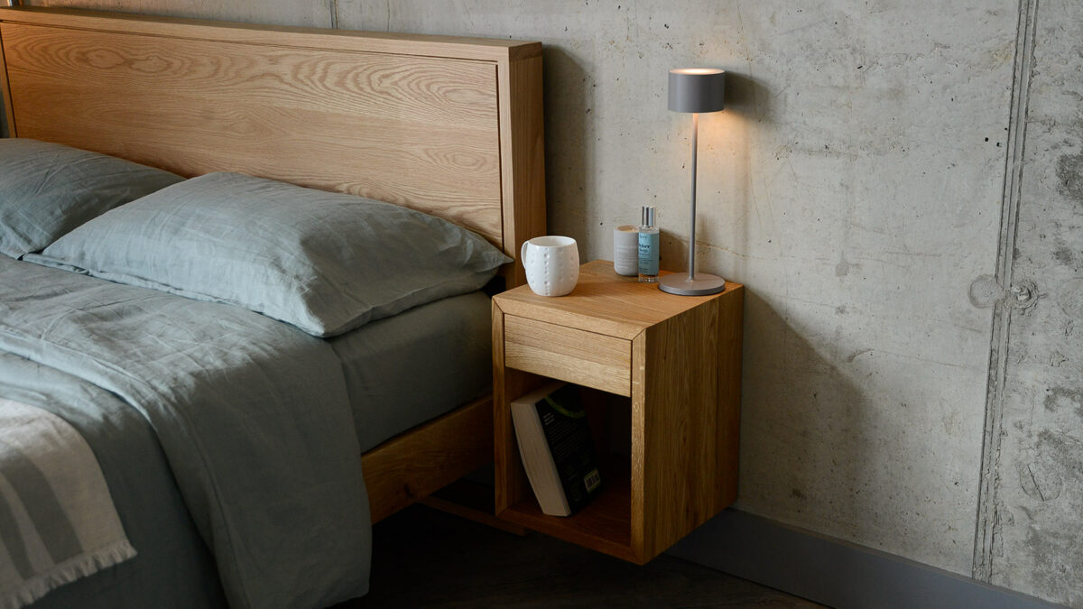 wall hung wooden bedside table with drawer in natural oak finish