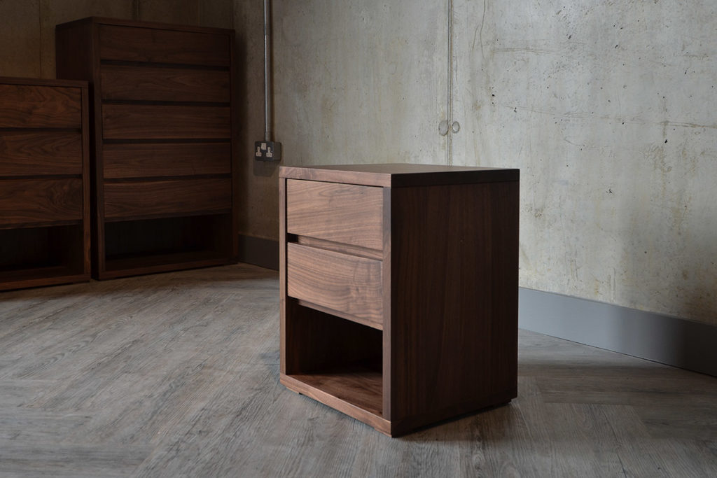 A side view of the Black Lotus 2 Drawer Cube Bedside Table in Walnut.