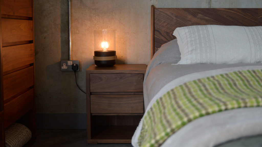 A walnut 2 drawer Cube Bedside table next to our Hoxton bed