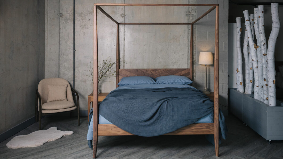 walnut 4 poster Harrow with dusk blue muslin bedspread