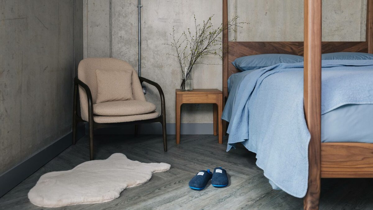 walnut 4 poster with boucle upholstered bedroom chair