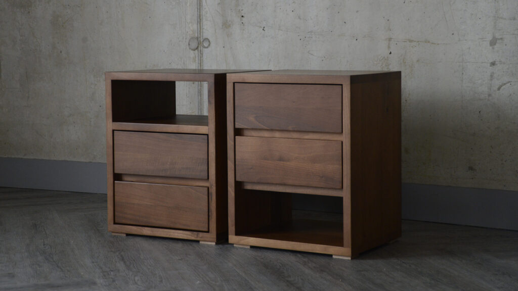 Two Black Lotus Cube bedside tables side by side. Image shows the two options available - either shelf at top or shelf at bottom.