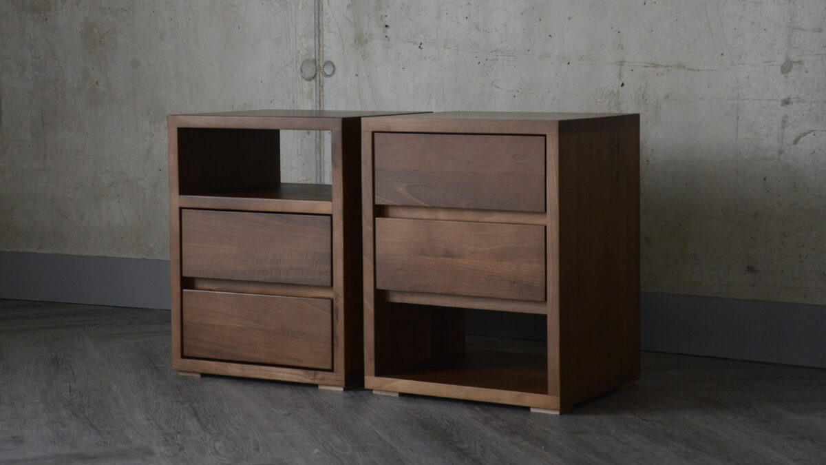 Two Black Lotus Cube bedside tables side by side. Image shows the two options available - either shelf at top or shelf at bottom.