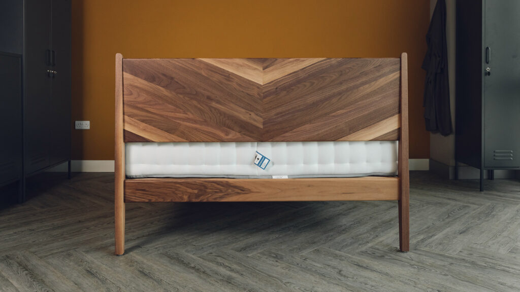 hand made walnut Hoxton bed with chevron pattern headboard shown from the back