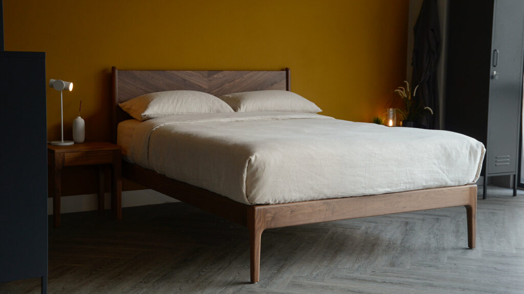 the Hoxton handcrafted solid wood bed with chevron pattern headboard here it is made in Walnut