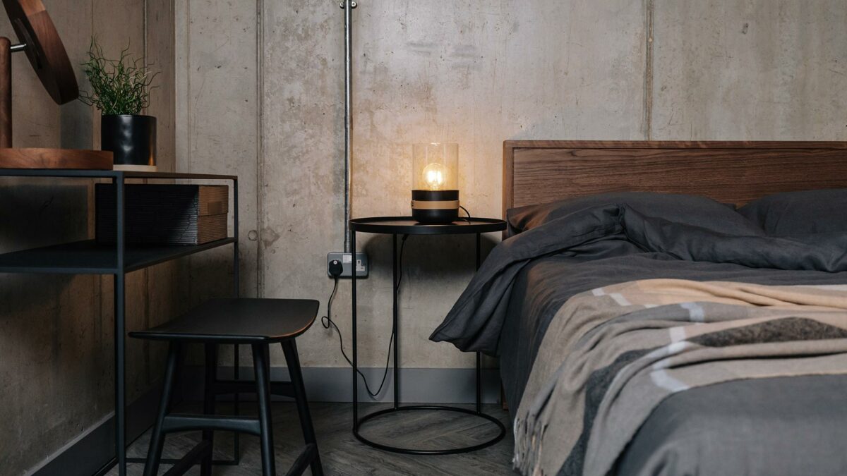 industrial style bedroom with Black furniture and a walnut wood Leith bed