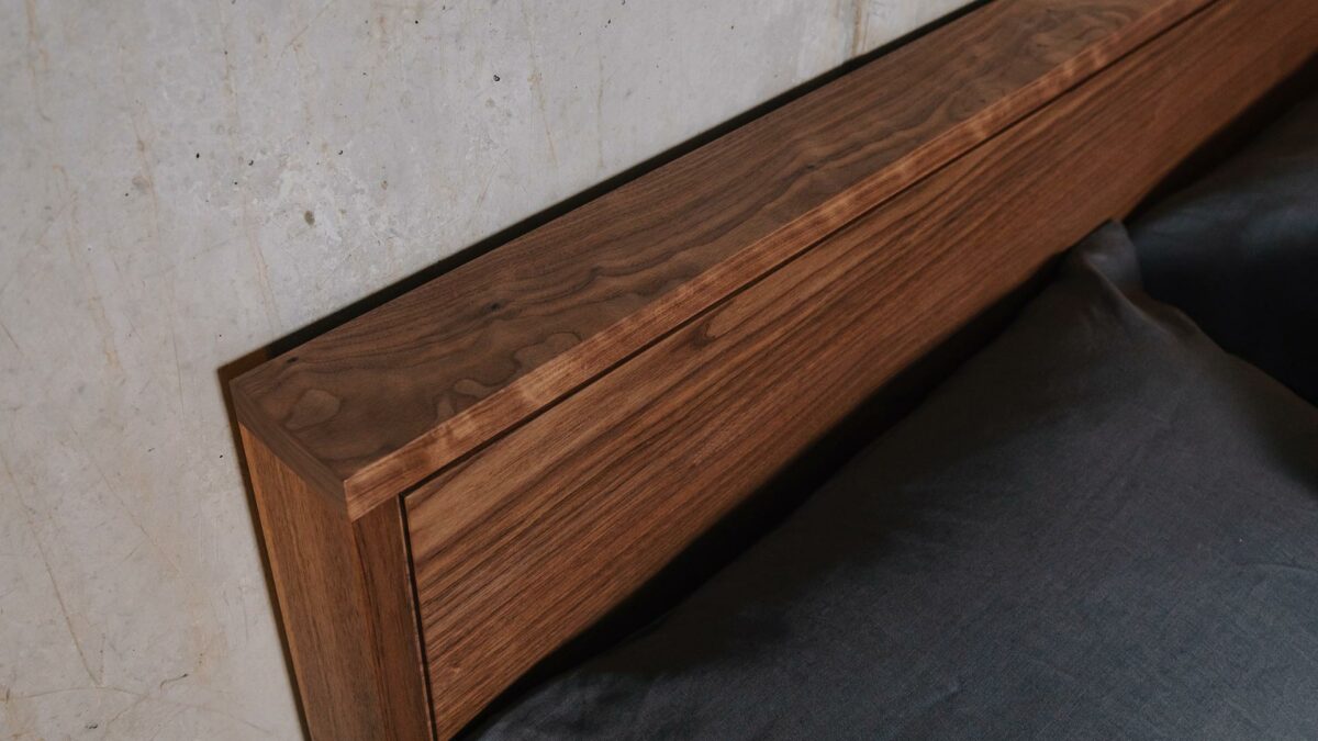 close up view of the handcrafted solid walnut headboard of the Leith bed