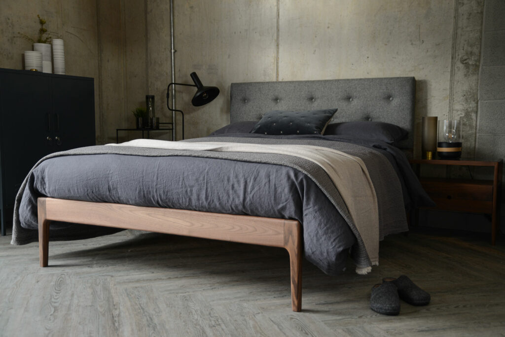 Scandinavian style bedroom featuring solid walnut framed Bloomsbury bed with grey upholstered headboard