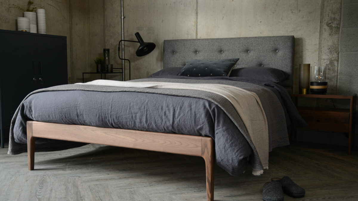 Scandinavian style bedroom featuring solid walnut framed Bloomsbury bed with grey upholstered headboard