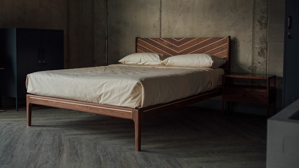 Solid wood hand-crafted bed in Walnut and maple, made in UK and available in a range of bed sizes