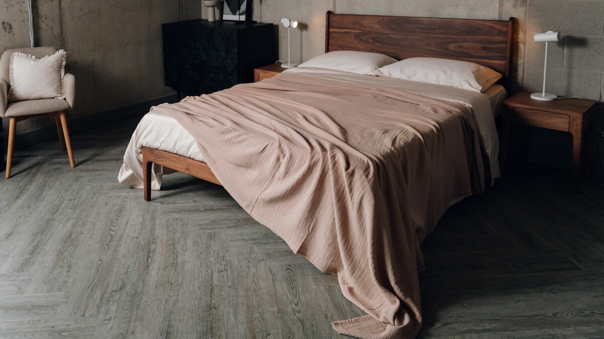 rose pink light textured bedspread shown draped on our kingsize oiled walnut Camden bed