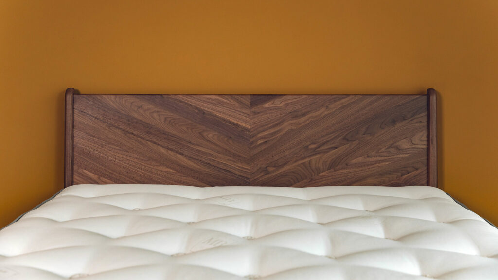 luxurious walnut Hoxton bed with chevron pattern headboard shown in close up